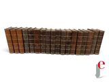 a group of books sitting on top of each other on a white surface
