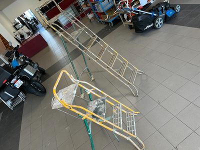 a shopping cart in the middle of a room with motorcycles in the background