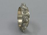 a close up of a silver ring on a white surface