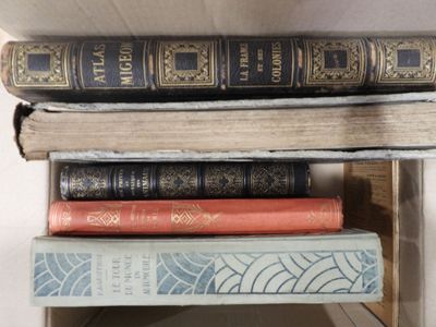 books stacked on top of each other on a shelf in a room
