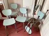 four chairs that are sitting next to each other in a room
