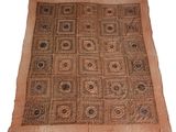 a brown and black rug on a white background