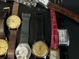 a lot of watches that are sitting on a table