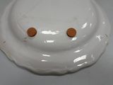 a white plate with two brown buttons on top of it