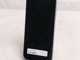 a black cell phone sitting on top of a white table