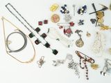 many different types of jewelry on a white surface