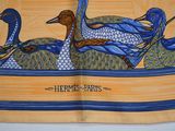 a blue and yellow scarf with a picture of ducks on it
