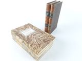 two books sitting on top of each other next to each other