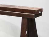 a wooden bench that is sitting on a white surface
