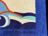towel with a picture of a surfboarder riding a wave on it
