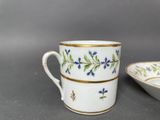 an image of a cup and saucer sitting on top of a table