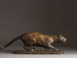 bronze statue of a panther on a wooden base
