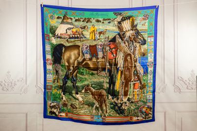 a tapestry hanging on the wall of a room with a horse and a man
