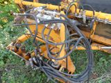 a machine that is sitting in the grass with wires attached to it
