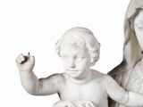 a statue of a woman holding a baby and a bird