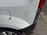 a close up of a car ' s rear end with the door open