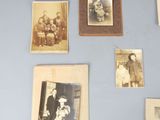 several old photos of people are displayed on a wall
