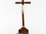 a wooden crucif with a cross and a green box