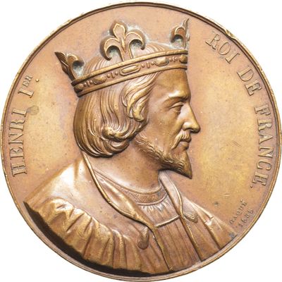 une image représentant une médaille d'or sur laquelle figure un homme coiffé d'une couronne