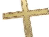 brass cross on a white background with a rope pattern