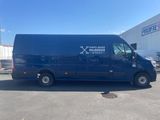 the blue van is parked in the parking lot outside of a building