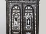 a black and white cabinet with a clock on top of it