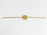 a gold bracelet with a coin on a chain