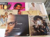 a lot of records on a table with a man ' s face