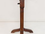 a wooden table with three legs and a wooden top