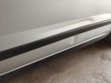 a close up of a white car with a black stripe