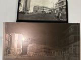 a person holding a picture of a city street