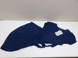blue pants on a white table with a tag on it