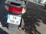 a motor scooter parked on the side of the street