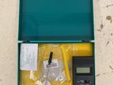 a green case with a digital thermometer in it