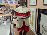 a statue of a woman holding a tray in a room