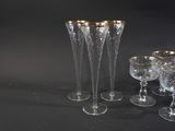 a group of wine glasses and a vase on a table