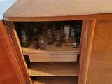 a small cabinet with a lot of bottles in it