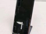 a black phone that is sitting on top of a stand
