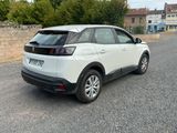 a white car that is parked on the side of the road