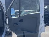 the door of a white truck is open on a parking lot