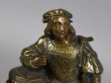 a bronze statue of a man holding a dog