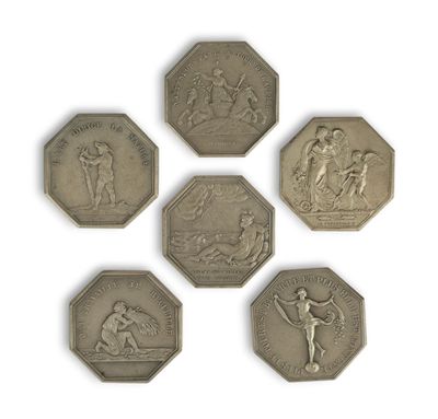 four silver coins with a picture of a man and a woman on them