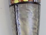 a vase with flowers on it sitting on a table