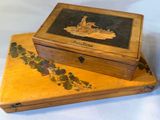 a wooden box with a painting on it sitting on a table
