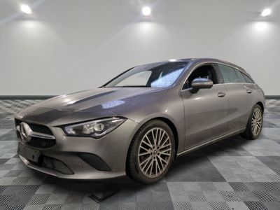 a grey mercedes cla parked on a checkered tile floor