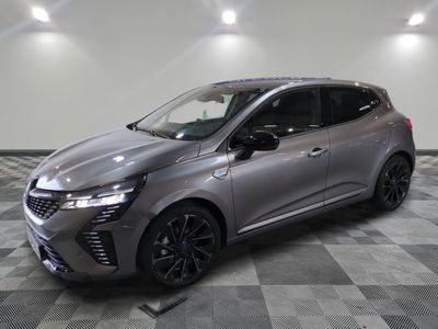 a grey car parked on a checkered tile floor in a garage