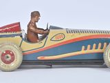 a small toy car with a man in the driver ' s seat