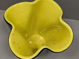 yellow flower shaped bowl sitting on top of a table