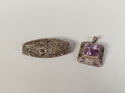 two silver and amethe pendants with amethe stones