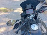 a close up of a motorcycle ' s handlebars and a mirror